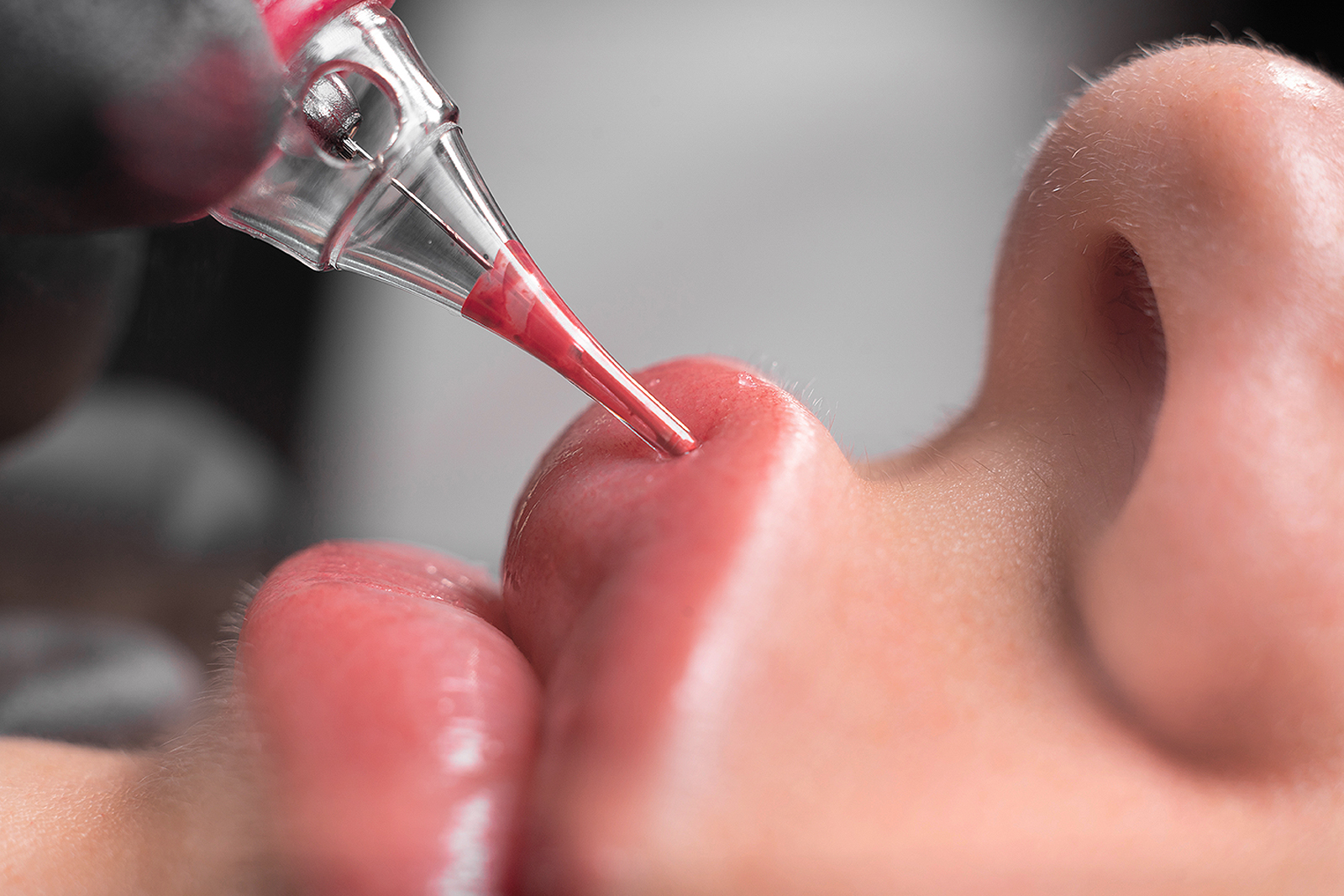 lip tattoo in a beauty salon, the process of applying coloring p